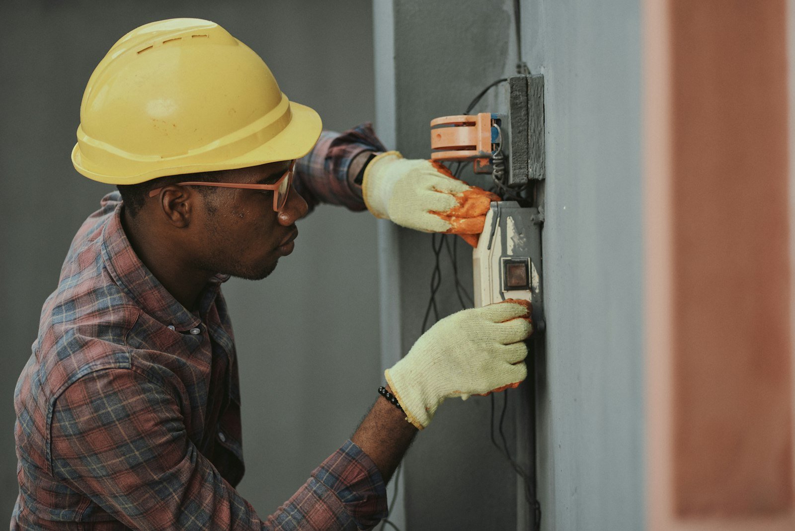 Electrician wiring a hybrid solar inverter installation