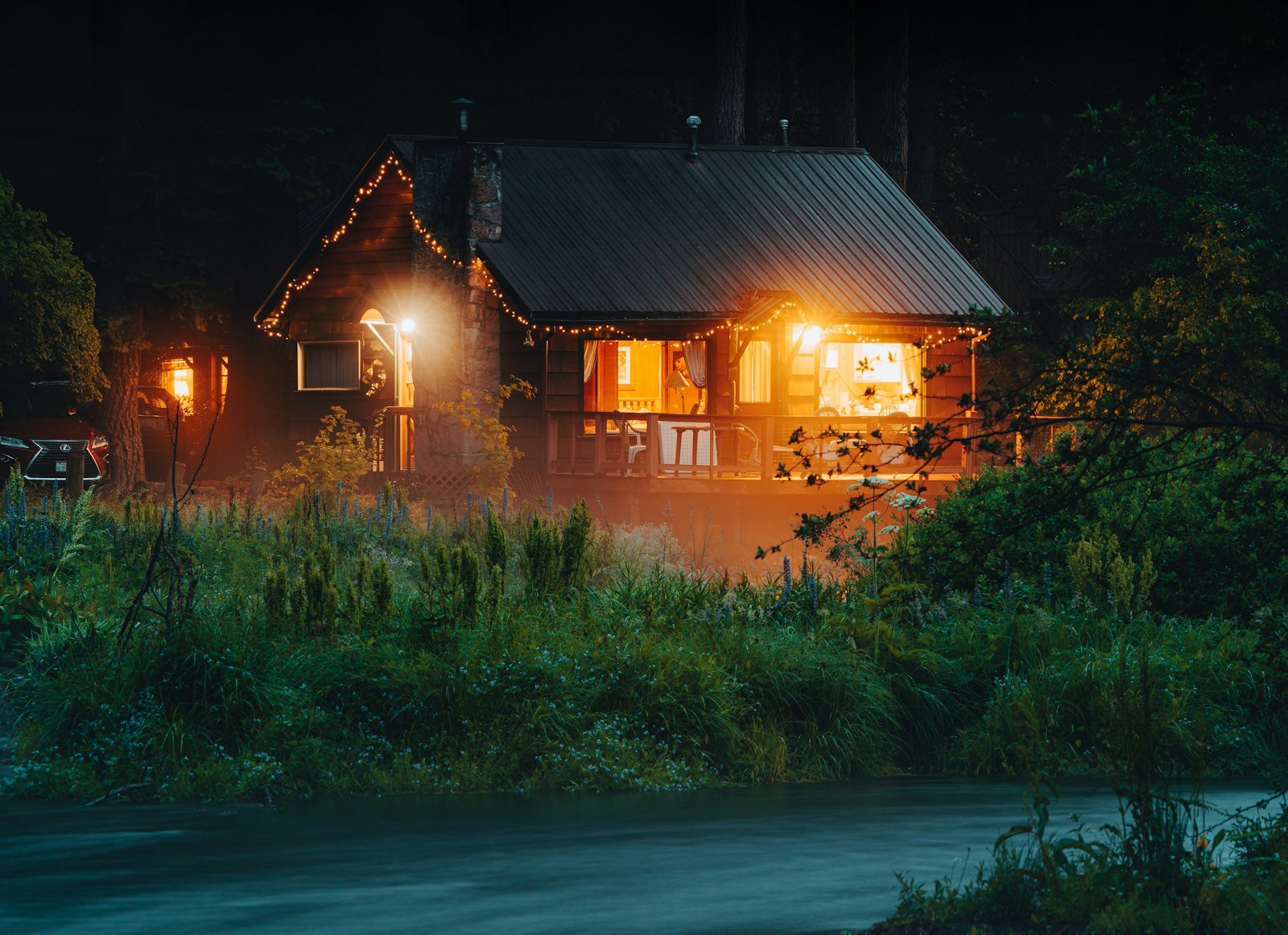 Home with lights on at night powered by solar battery backup during load shedding