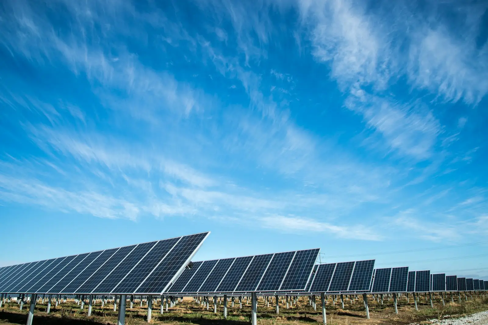 Rows of solar panels under a clear blue sky