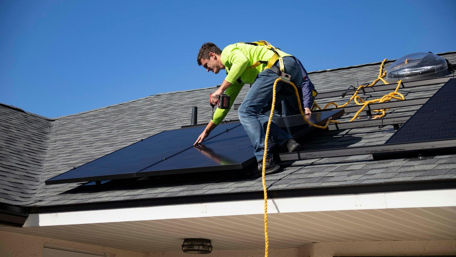 Solar technician installing panels for a home backup system