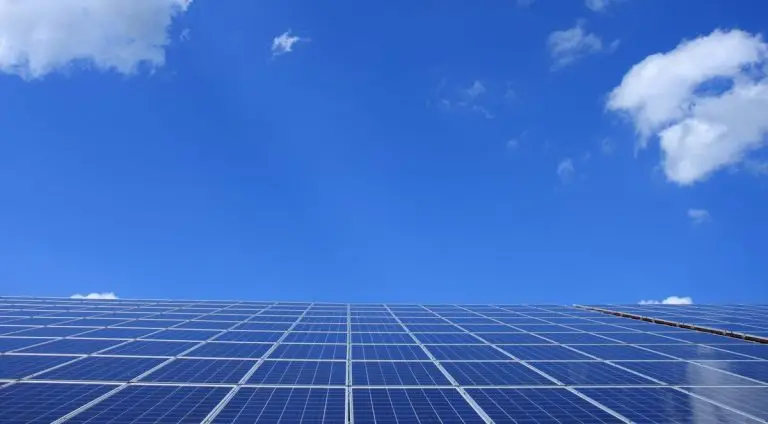 Blue solar panels under a sunny sky - depth of discharge battery