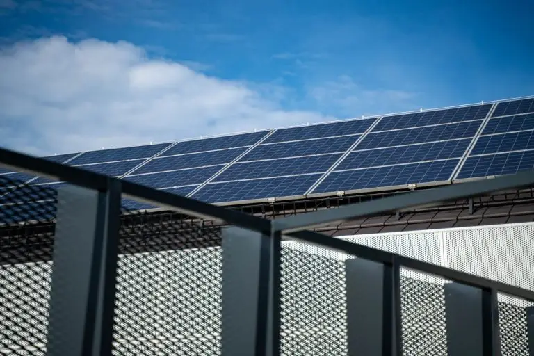 Blue solar panels on a roof - water motor on solar inverter