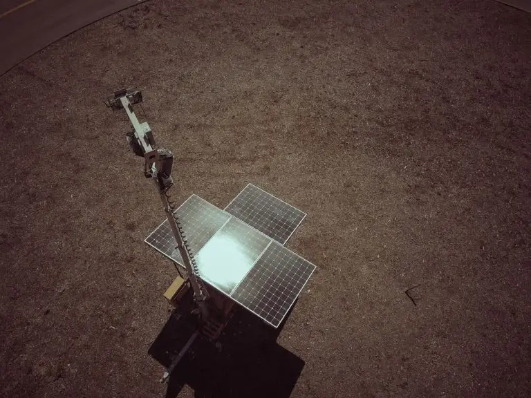 Drone shot of solar panels on grass - reduce electricity load before solar