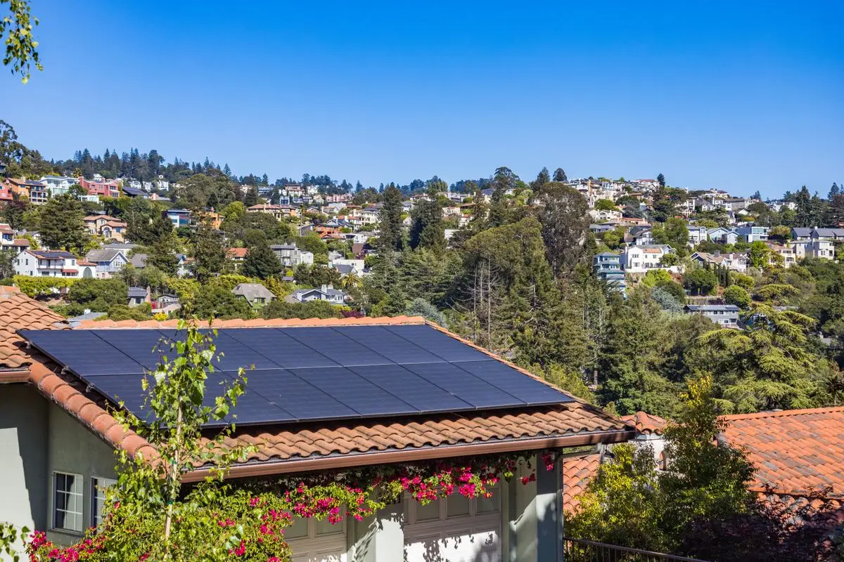 House with solar panels on the roof - three phase solar inverter