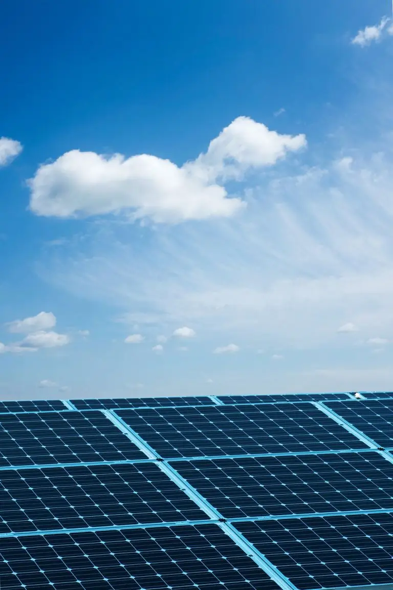 Solar panels under a blue cloudy sky - solar for shops